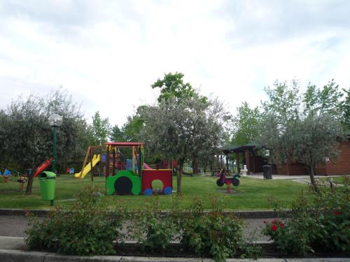 a park with a playground with a slide at The Garda Village in Sirmione