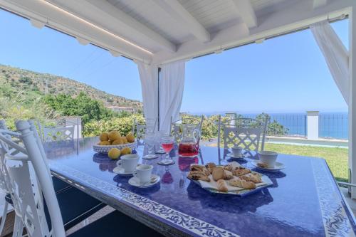 a blue table with food and drinks on a balcony at Villa Greta in Porto San Giorgio