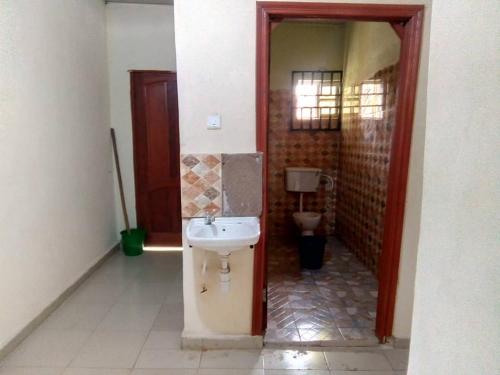 a bathroom with a sink and a toilet at Edo Home in Benin City