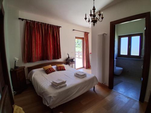 a bedroom with a bed with towels on it at Agriturismo Cascina Marchesa in Bussoleno