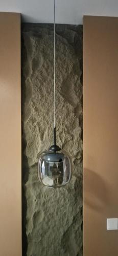 a silver light hanging from the ceiling of a room at Habitat Service Apartment in Ilado