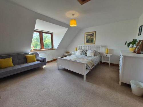 a bedroom with a bed and a couch at Tylone in Lochdon