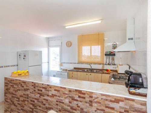 a kitchen with a brick counter top in a room at Holiday Home Panoramic by Interhome in Tordera