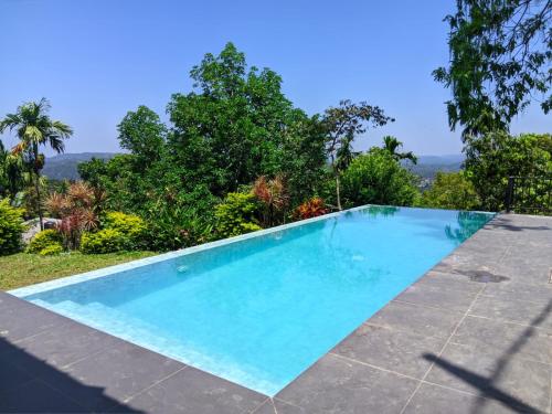 a swimming pool in the backyard of a house at The Montfort - Kandy in Kandy