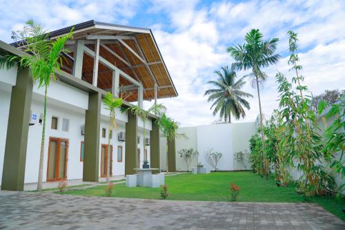 
a large white house with a large window at Cloud 9 Boutique Hotel in Negombo
