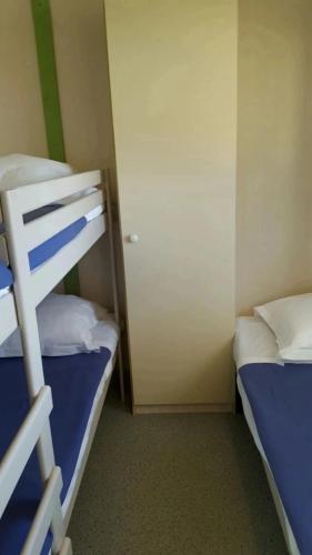 a small room with two bunk beds and a door at Camping 3 étoiles - Piscine - ccbfihb in Casaglione