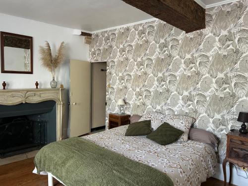 a bedroom with a bed in front of a wall at Chambre d'hôtes - demeure historique in Chantenay-Saint-Imbert