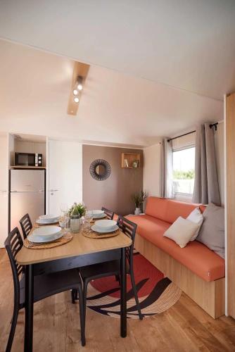 a living room with a table and a couch at Camping 2 étoiles - Piscine - ccbgb0d in Sospel