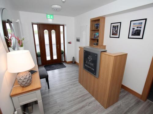 a waiting room with a desk and a tv at All Seasons B&B in Portrush