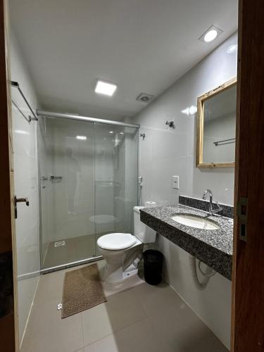 a bathroom with a shower and a toilet and a sink at Danny's Hotel in Tailandia