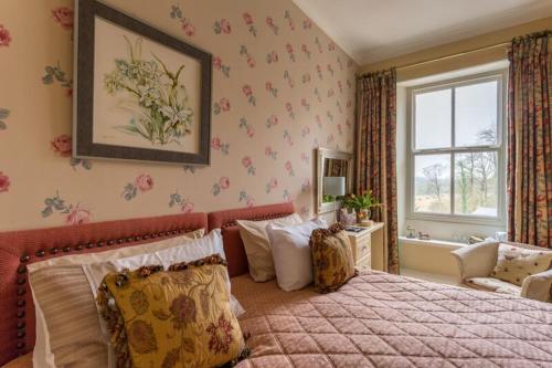a bedroom with a large bed and a window at challan hall in Silverdale