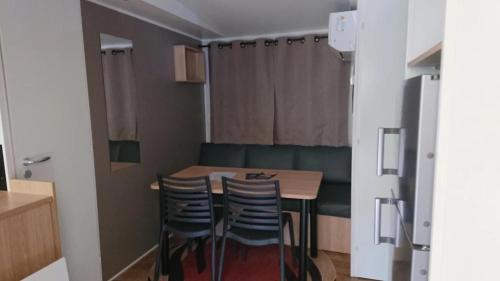 a small dining room with a table and chairs at Camping 2 étoiles - Piscine - ccbfiif in Avignon