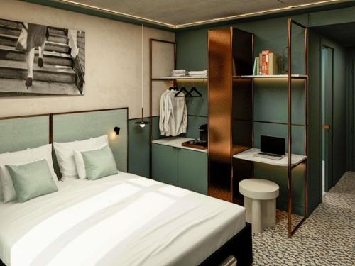 a bedroom with a bed and a desk with a laptop at TRIBE Hôtel Le Touquet in Le Touquet-Paris-Plage