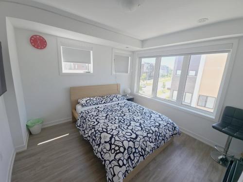 a bedroom with a bed and a large window at Downsview Park Retreat 1 - Rogers Stadium Getaway in Toronto