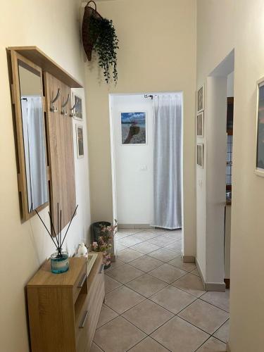 a hallway with a bathroom with a mirror and a door at Vista mare in San Vincenzo