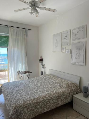 a bedroom with a bed and a ceiling fan at Vista mare in San Vincenzo
