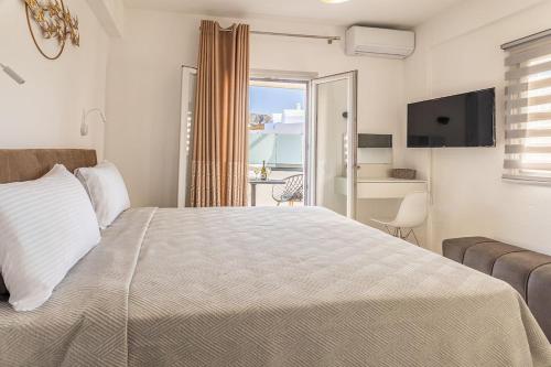 a bedroom with a bed and a view of the ocean at Ageri Suite II in Vóthon