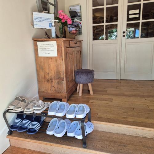 a group of shoes on a shelf in a room at Le Mas de Rigoulac SPA sur réservation et table d'hôtes tout les jours sauf les jeudis et les dimanches in Bouyssounouse