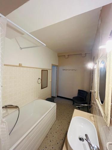 a white bathroom with a tub and a sink at Chambre d'hôtes - demeure historique in Chantenay-Saint-Imbert