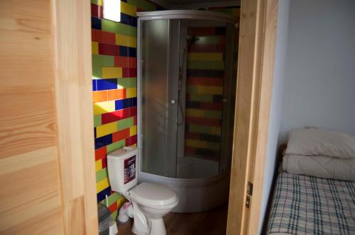 a colorful bathroom with a shower and a toilet at Hostel MIF in Ivano-Frankivsʼk