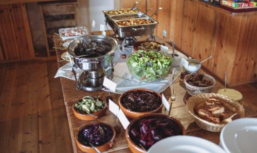 a table with various dishes of food on it at Hotel Langaholt in Langaholt