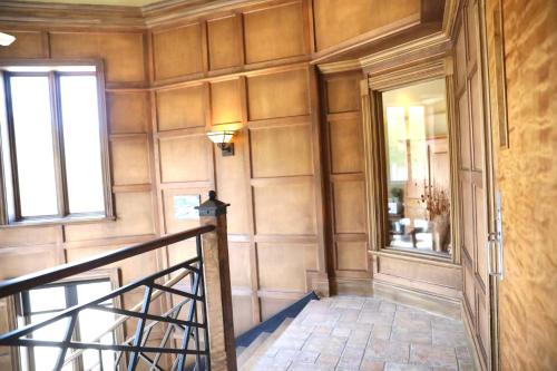 a hallway of a home with a staircase and a window at La Remontée Appartements Hôtel in La Malbaie