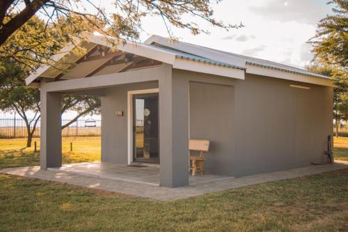 a small building with a porch and a door at Benedicto Farm in Welkom