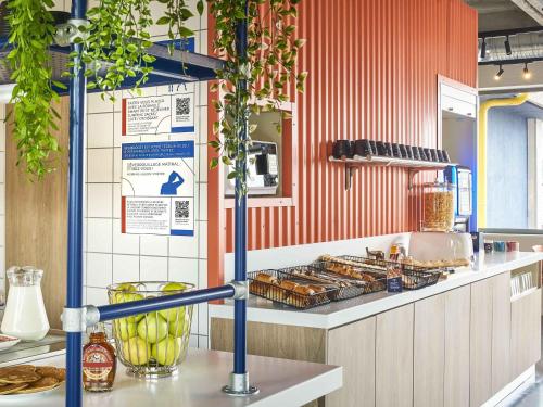 a kitchen with a counter with some food on it at ibis budget Nancy Laxou in Nancy