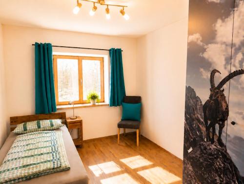 a bedroom with a bed and a window at AlpStern Ferienwohnungen Oberstdorf in Oberstdorf