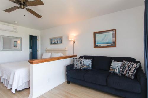 a living room with a couch and a bed at Beach Plum Resort in Montauk