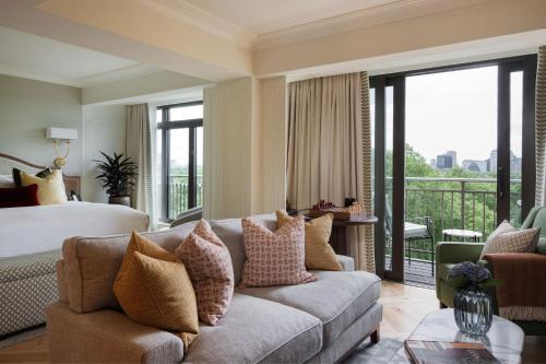 a living room with a couch and a bed at The Athenaeum Hotel & Residences in London