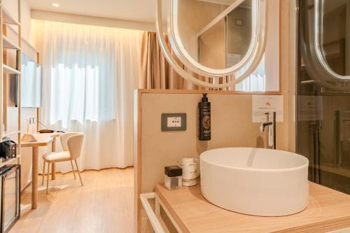 a bathroom with a large white tub in a room at Modica Inn Centro, BW Premier Collection in Modica