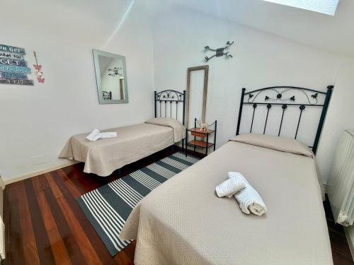 a room with two beds and a mirror at Apartamento La Bruma 30807 in Somo