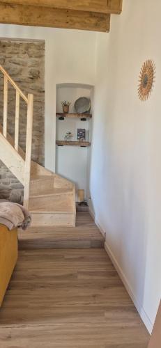 a staircase in a room with wooden floors at Duplex Le Trèfle in Charmes-sur-lʼHerbasse