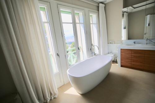a white bath tub in a bathroom with a window at Villa Cœur de Mer in Nice