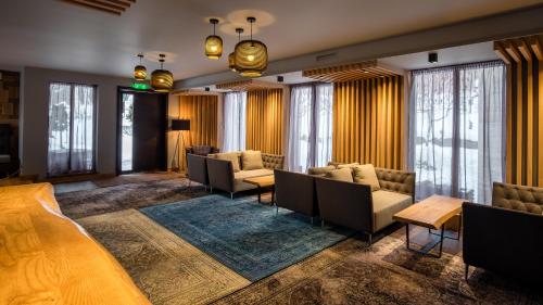 a hotel lobby with couches and tables and windows at 6aTo Hotel & Spa in Sofia
