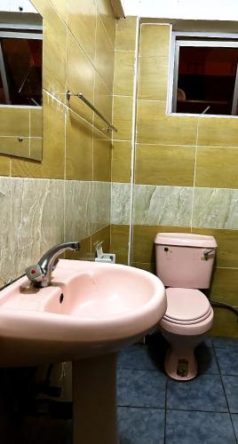 a bathroom with a sink and a toilet at Charonyi Safari Lodge in Gutini