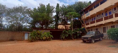 a truck parked in front of a building at Charonyi Safari Lodge in Gutini