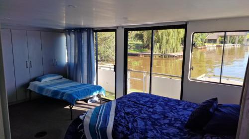 a room with two beds and a large window at Old Willow Houseboats in Sasolburg