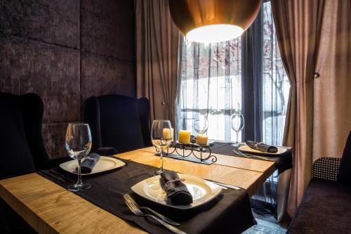 a table with two glasses and a plate of food at Vila 6aTo Hotel & Wellnes in Sofia