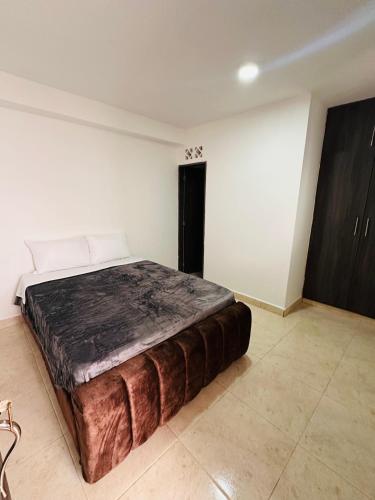 a bedroom with a large bed in a room at Aluna Hotel, Laureles Medellín in Medellín