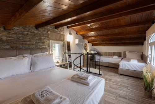 a bedroom with a large bed and a living room at En Sophia Guesthouse in Maronia