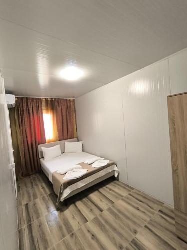 a bedroom with a bed in a room at For Fun resort naturist libertin - adults only in Costinesti
