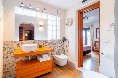 a bathroom with a sink and a toilet at Cubo's Villa La Gitanilla in Mijas