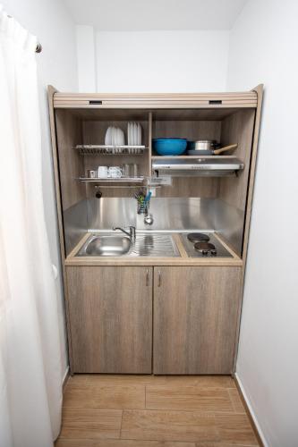 a small kitchen with a sink and a sink at Littore Maris in Nea Vrasna