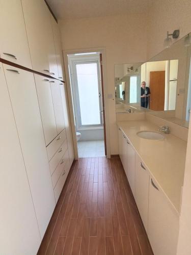 a bathroom with a sink and a mirror at Nireas Crystal in Aglantzia