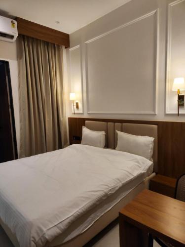 a hotel room with a bed and a table at Hotel Manchester Royals LLP in Boria Kalān