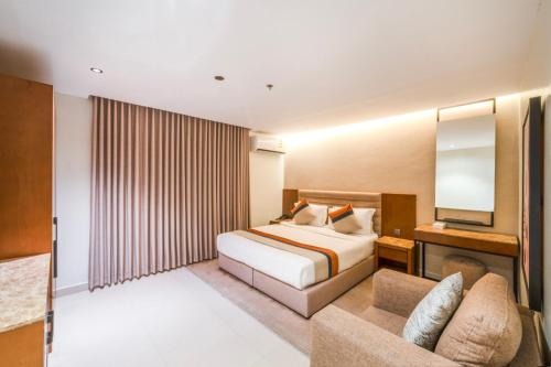 a hotel room with a bed and a couch at Nawara Dala - Economic in Riyadh