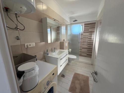 a bathroom with a sink and a toilet and a shower at More Space, More Memories -Lana Rab Apartment in Rab
