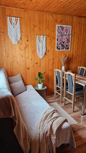 a bedroom with a bed and a table and chairs at Nad Andruszkowianką in Andruszkowice